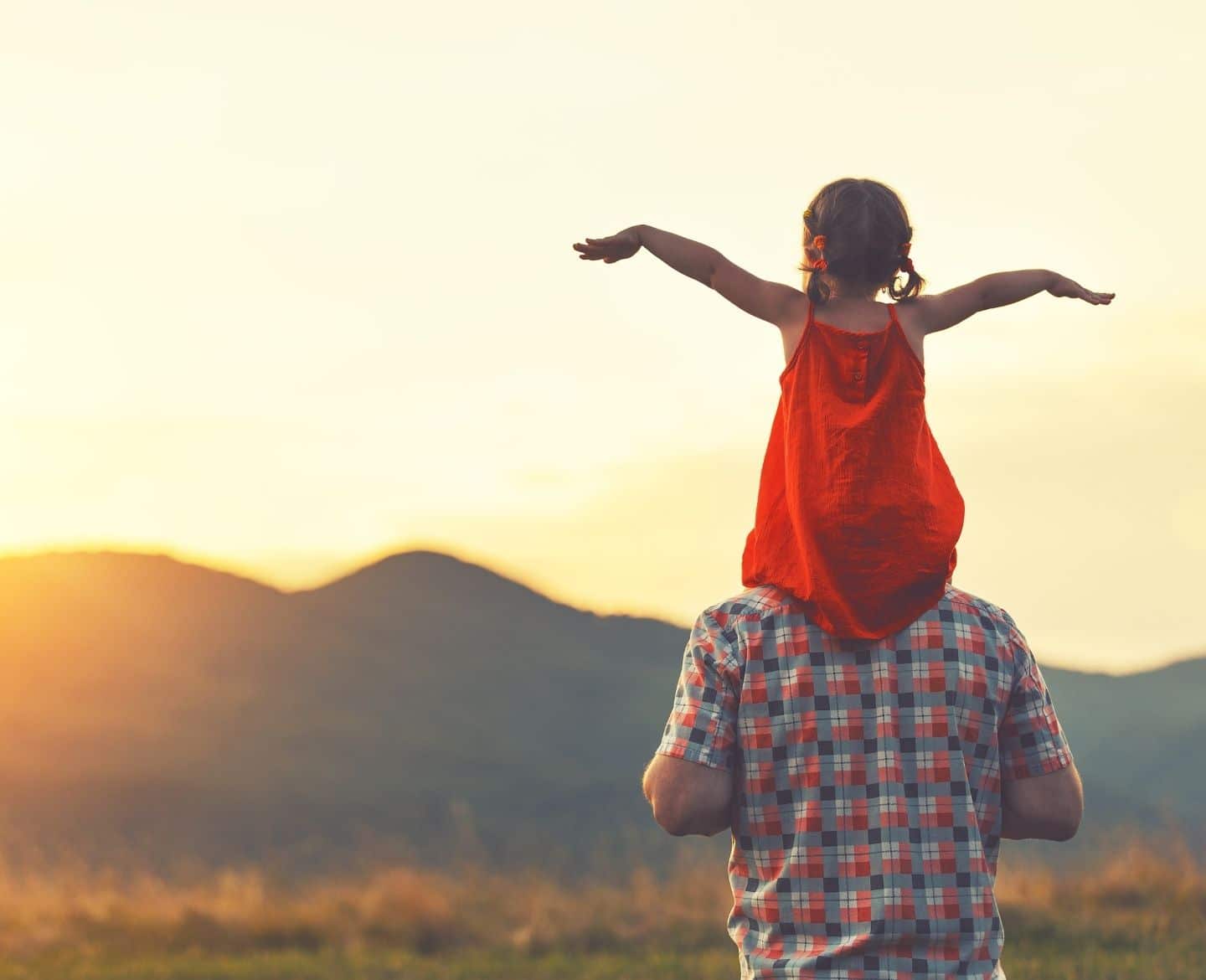 daughter on dads shoulders