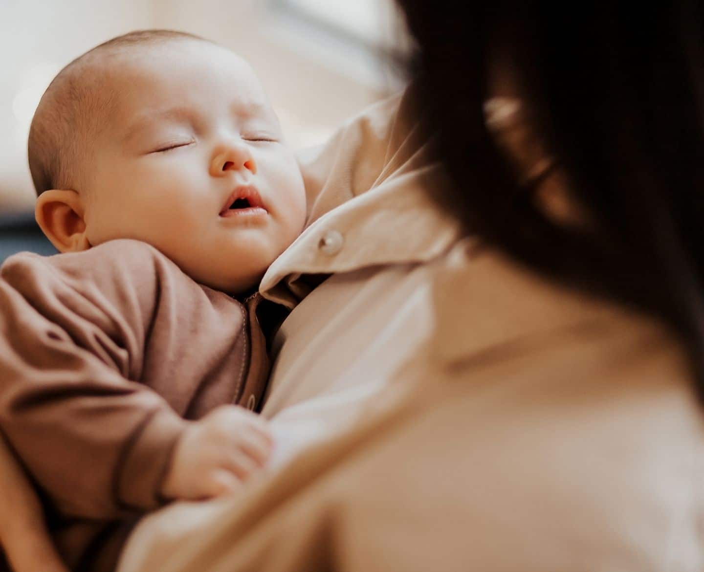 SIDS research study: mother holding sleeping baby