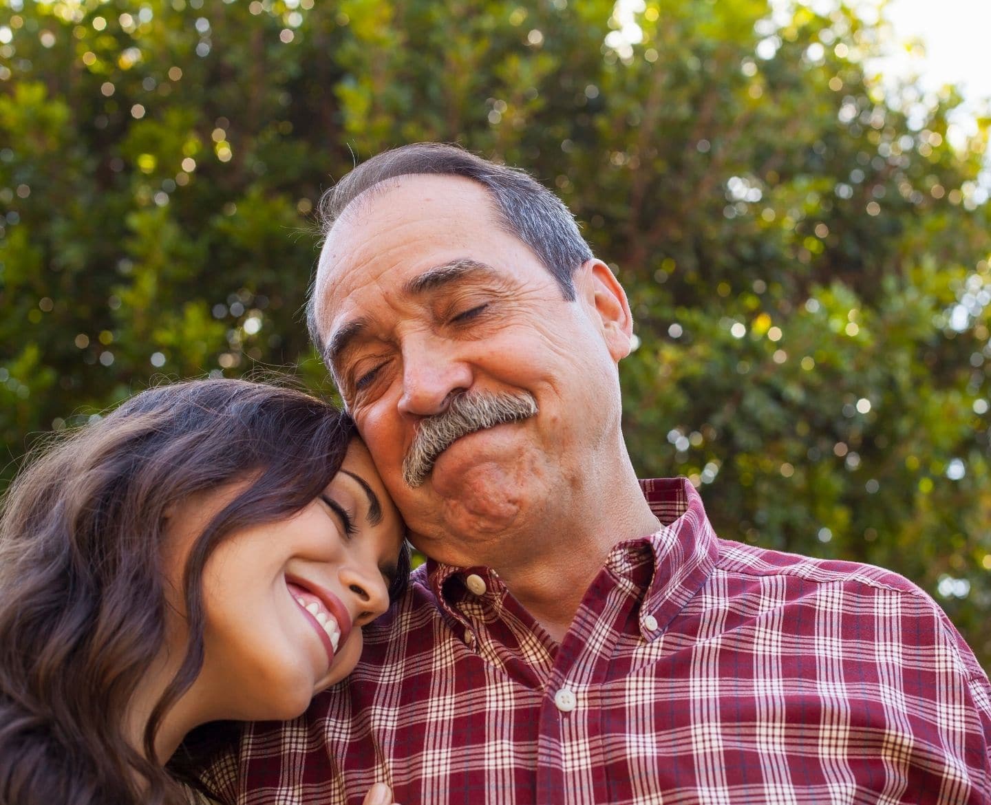 smiling daughter laying her head on father's shoulder- letter to my dad