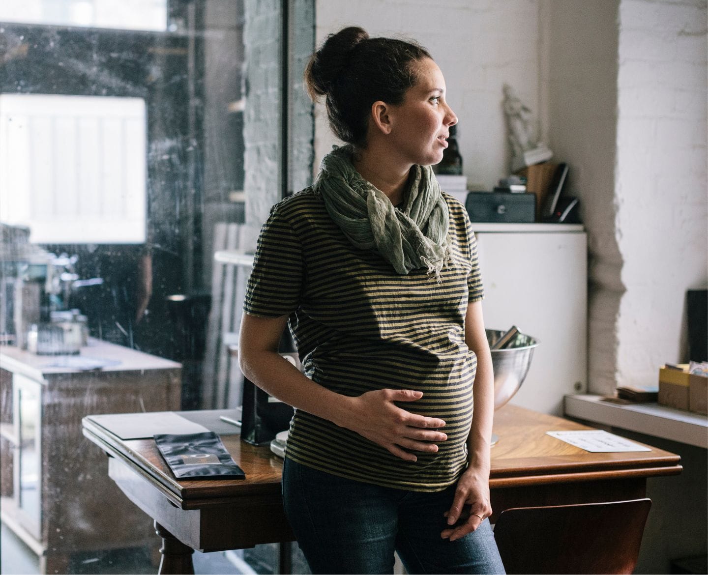 pregnant woman at work looking away