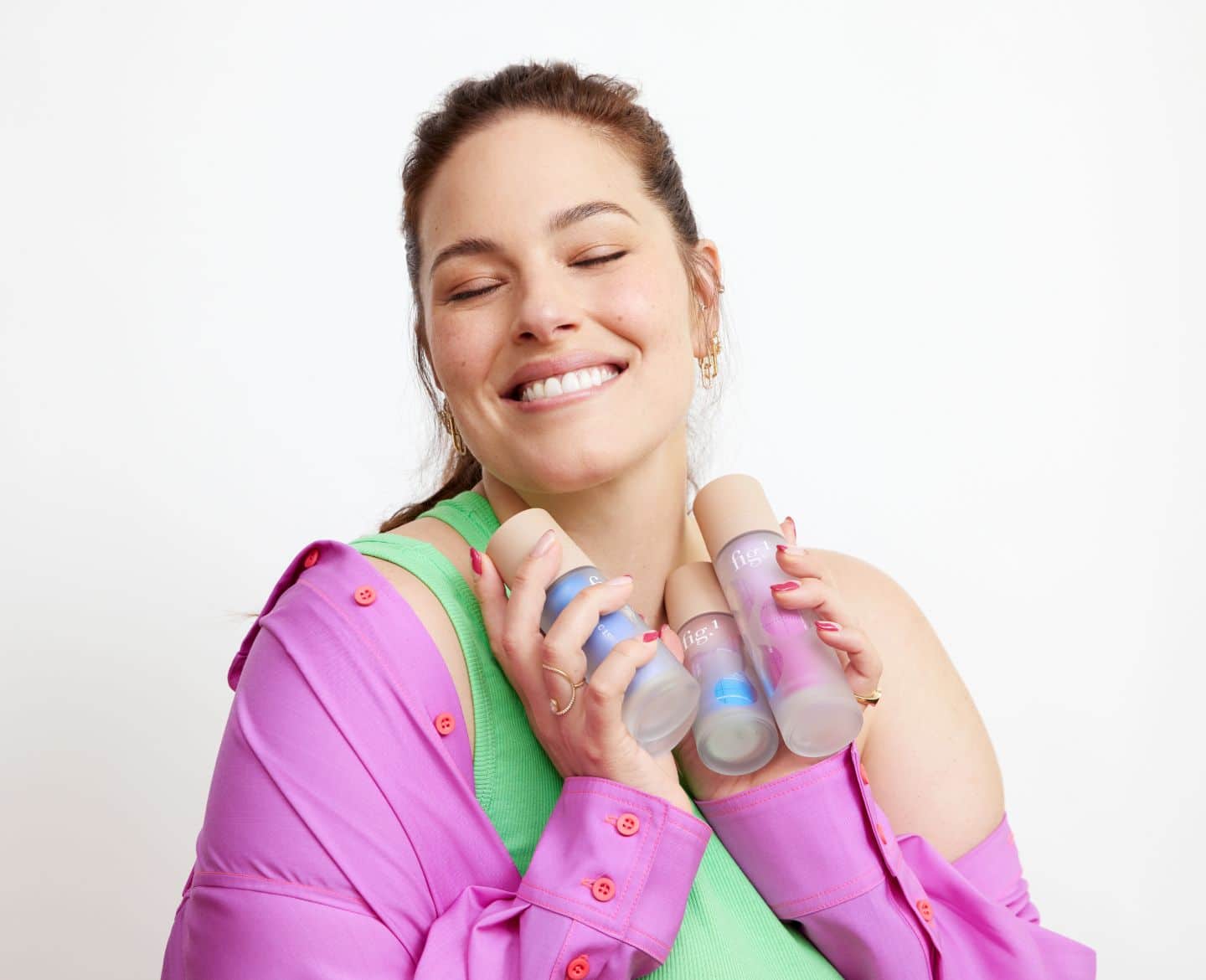 Ashley Graham holding Fig. 1 skincare