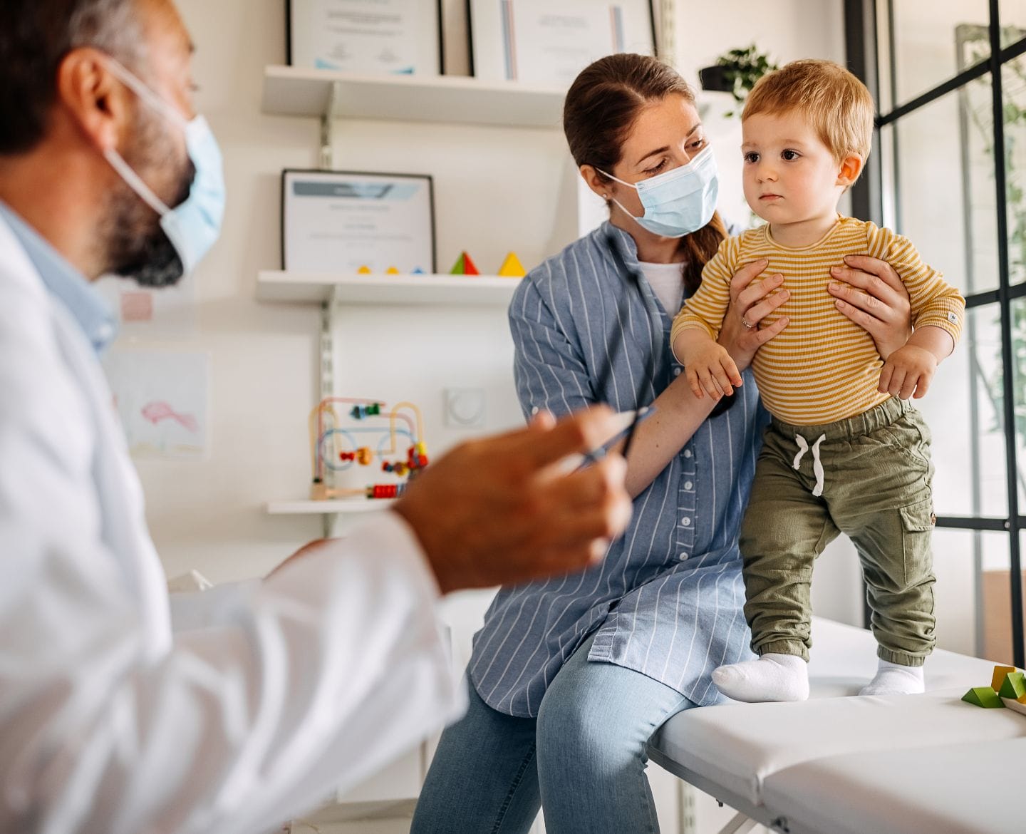 Mother and baby son at doctors office for vaccine