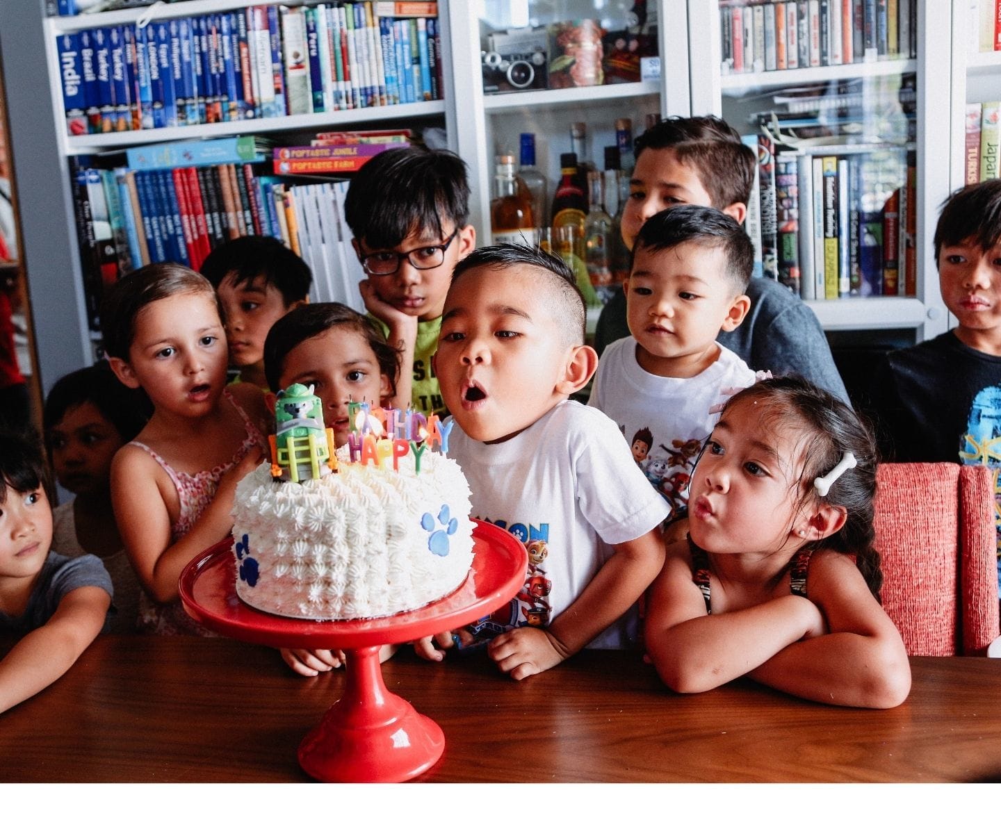 no-gift birthday party: diverse group of kids around birthday cake