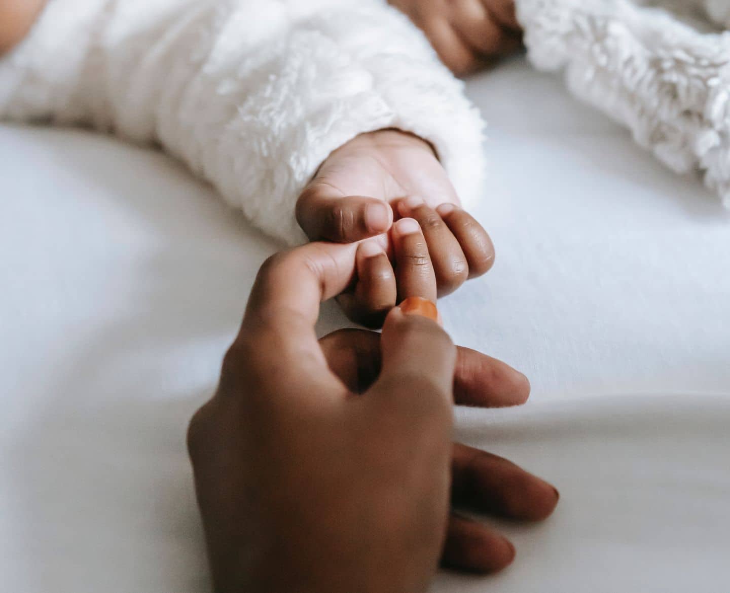 mom holding daughters hand