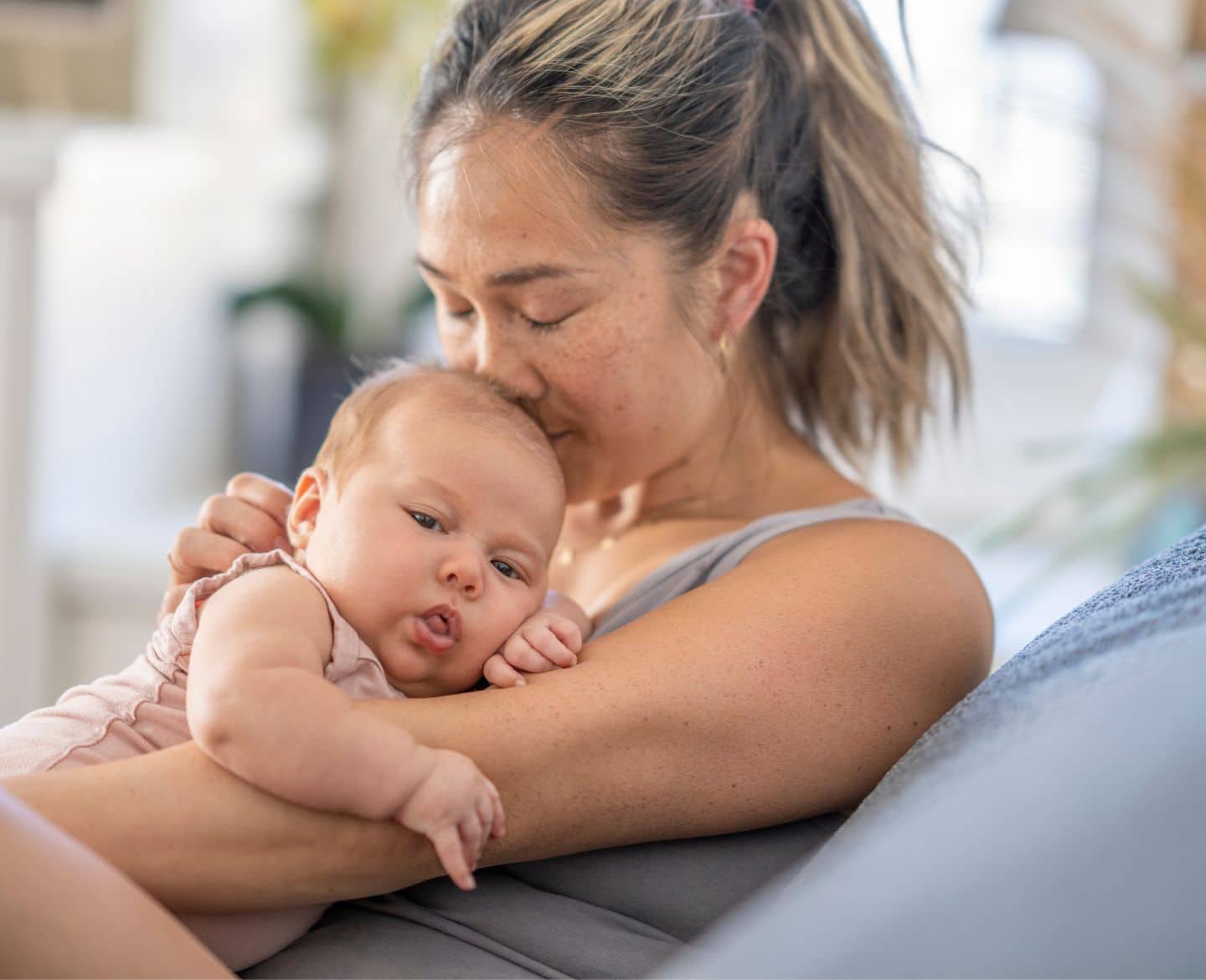 mom kissing baby's head