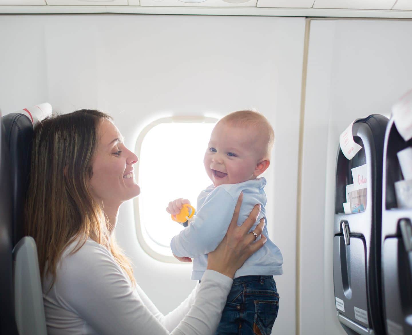 mother with baby on airplane- flying with breast milk