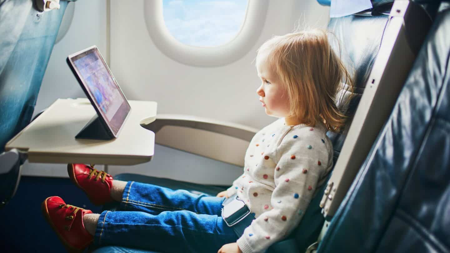 Little girl sitting on an airplane