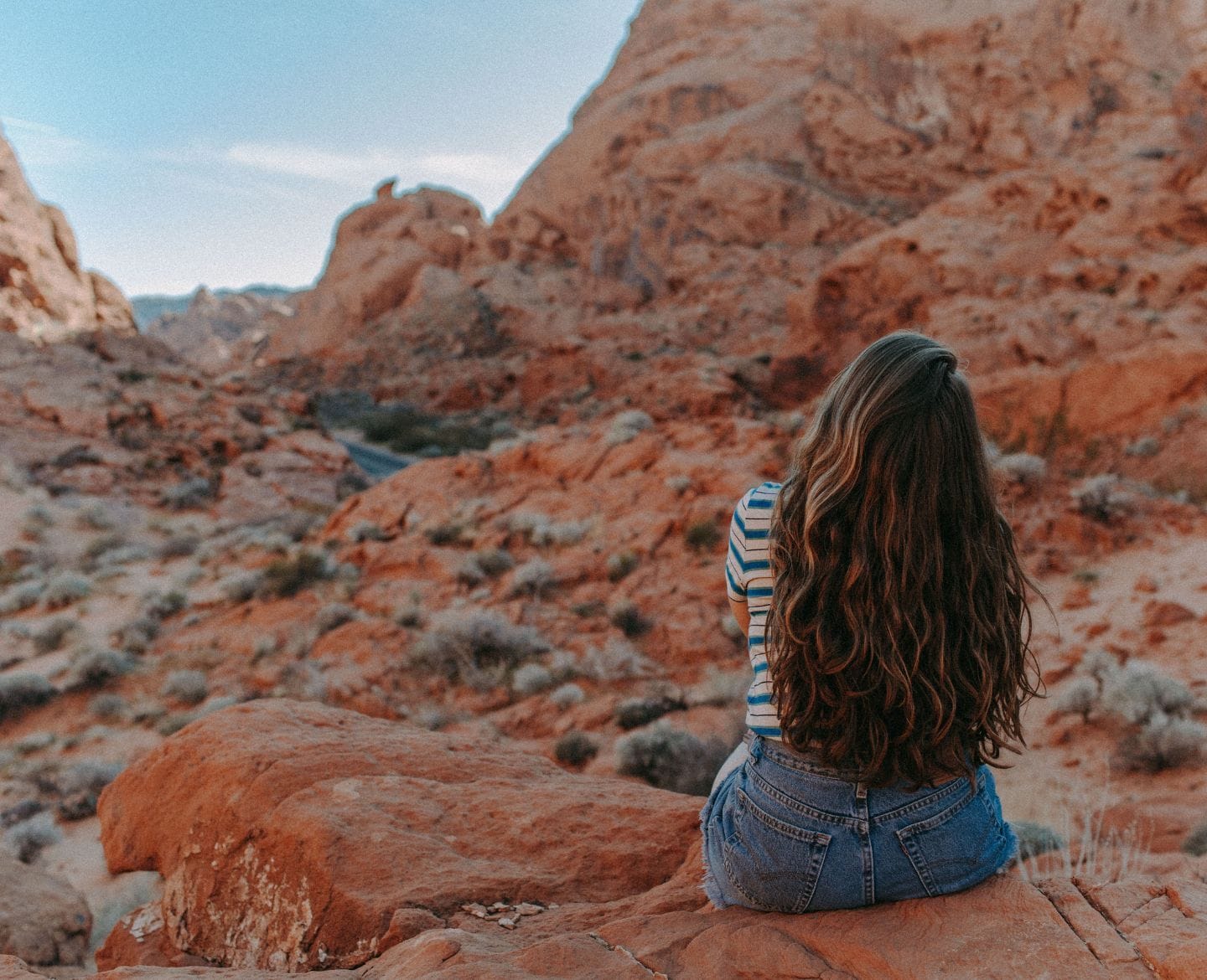 woman sitting by herself in the desert