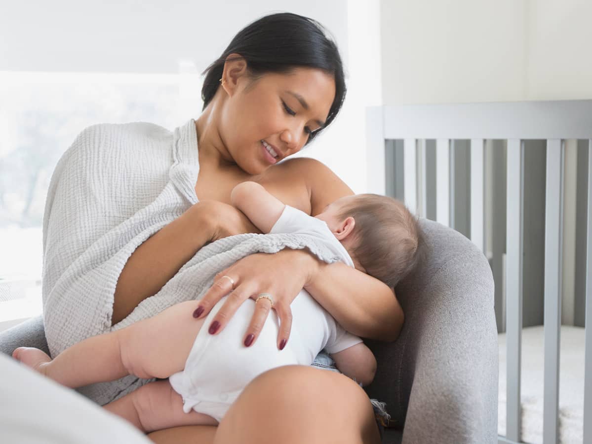 Woman sitting in armchair breast-feeding.jpg