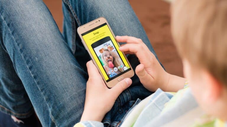 Young boy using Snapchat on a smartphone