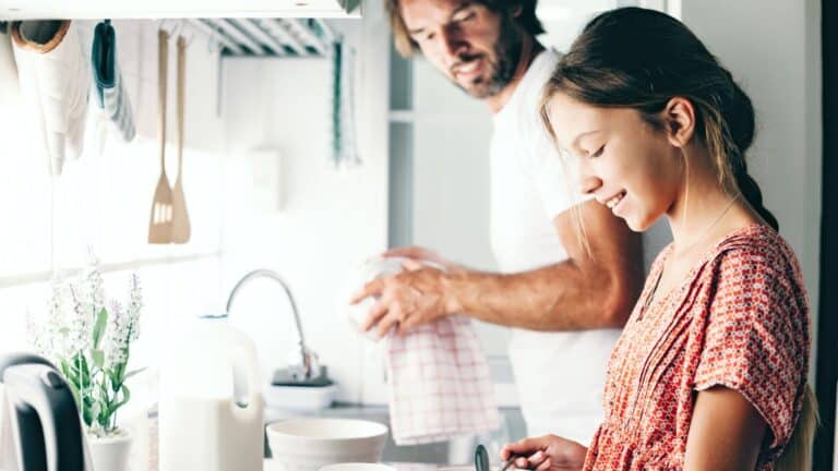 Dad and daughter in kitchen - bivalent boosters for kids