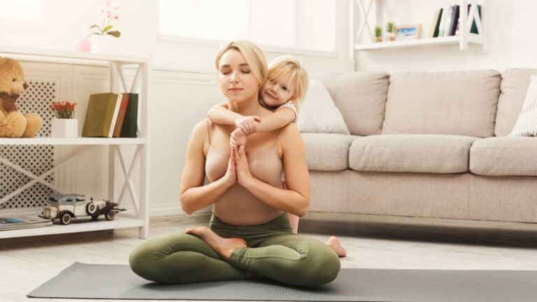 mom doing yoga with child trying to avoid mom burnout