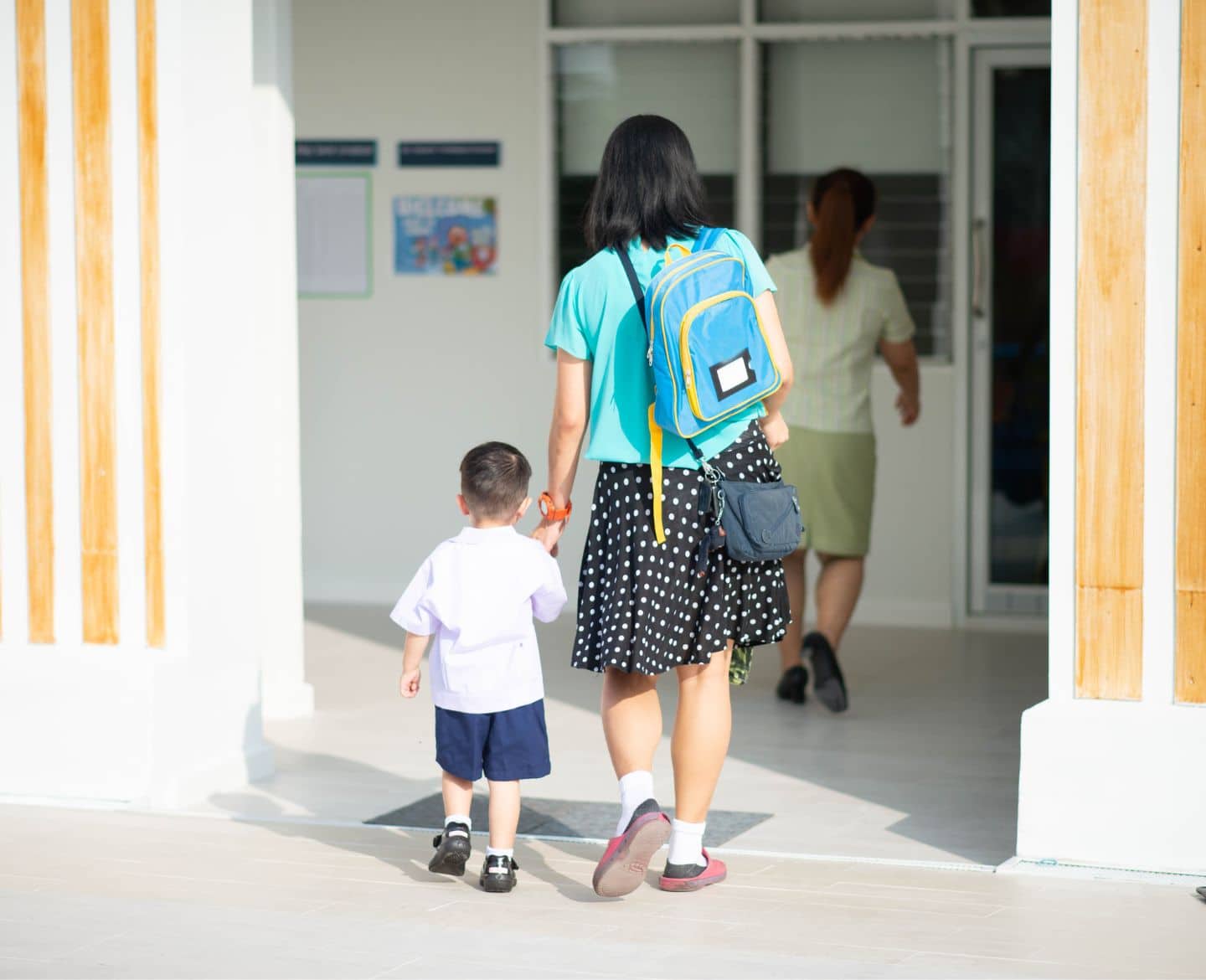 mom holding son's hand-walking to preschool