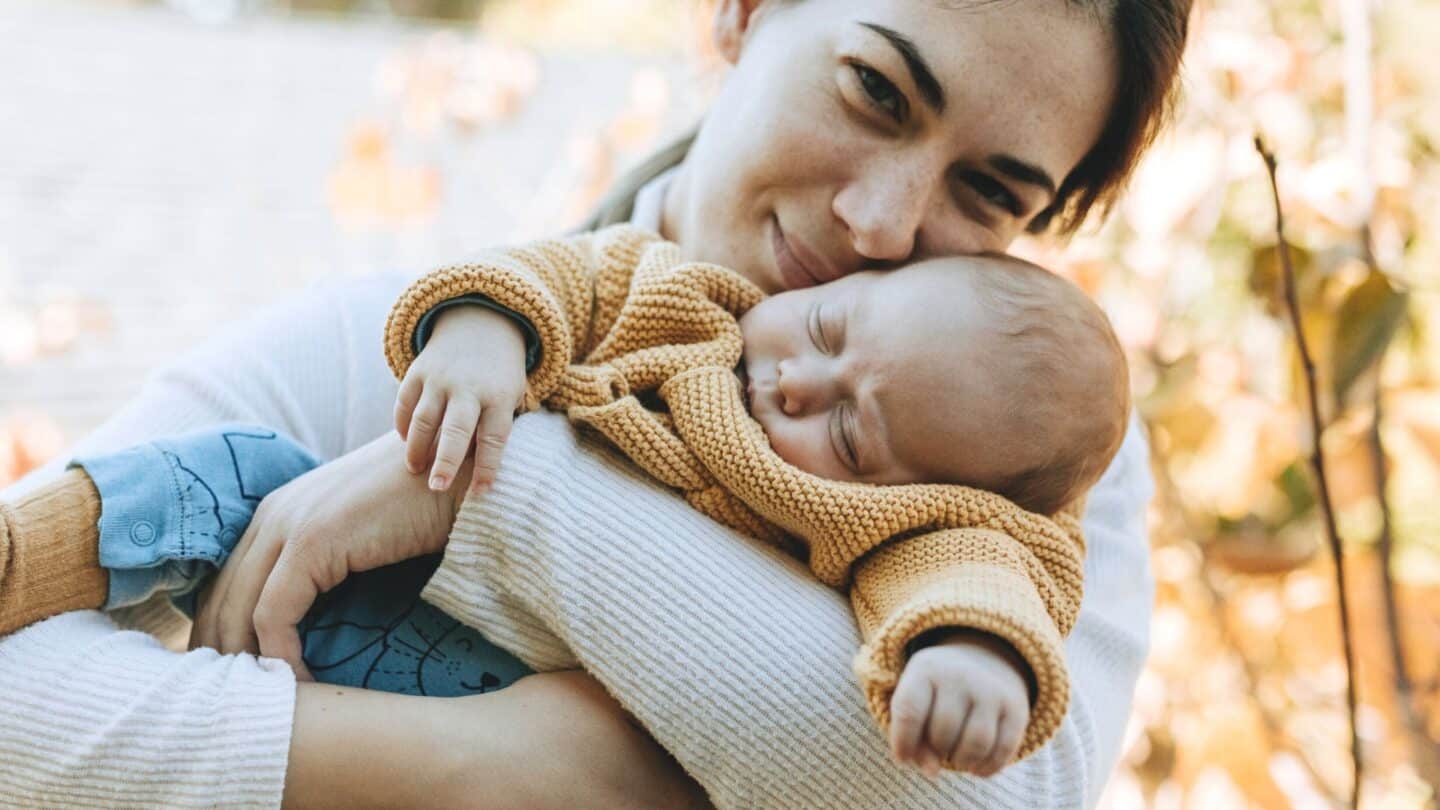 mother holding baby in her arms - benefits of taking vitamin d during pregnancy