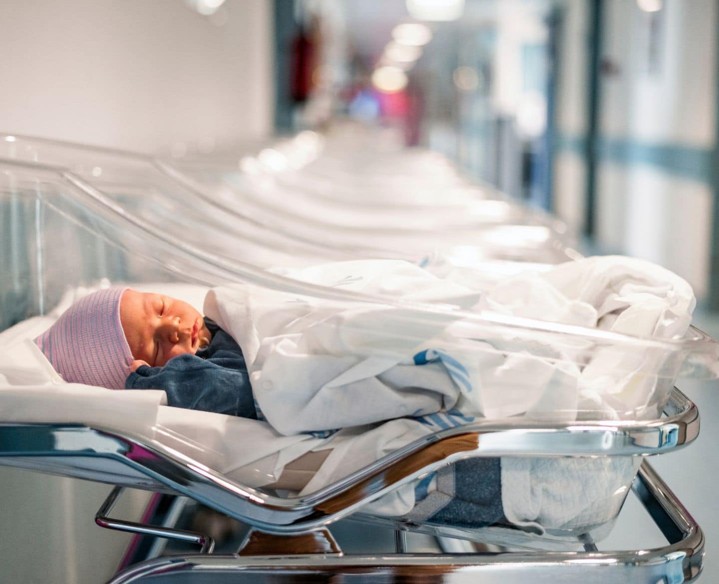 newborn baby in hospital bassinet - early term birth and adhd