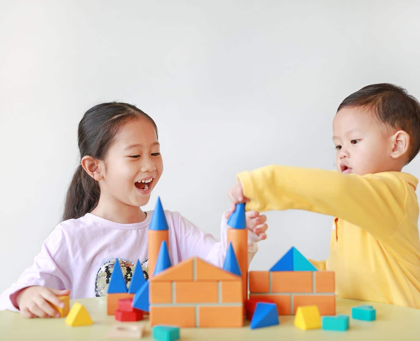 two kids building a castle together - creative play