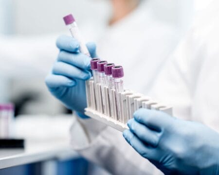 woman using test tubes in a lab Motherly