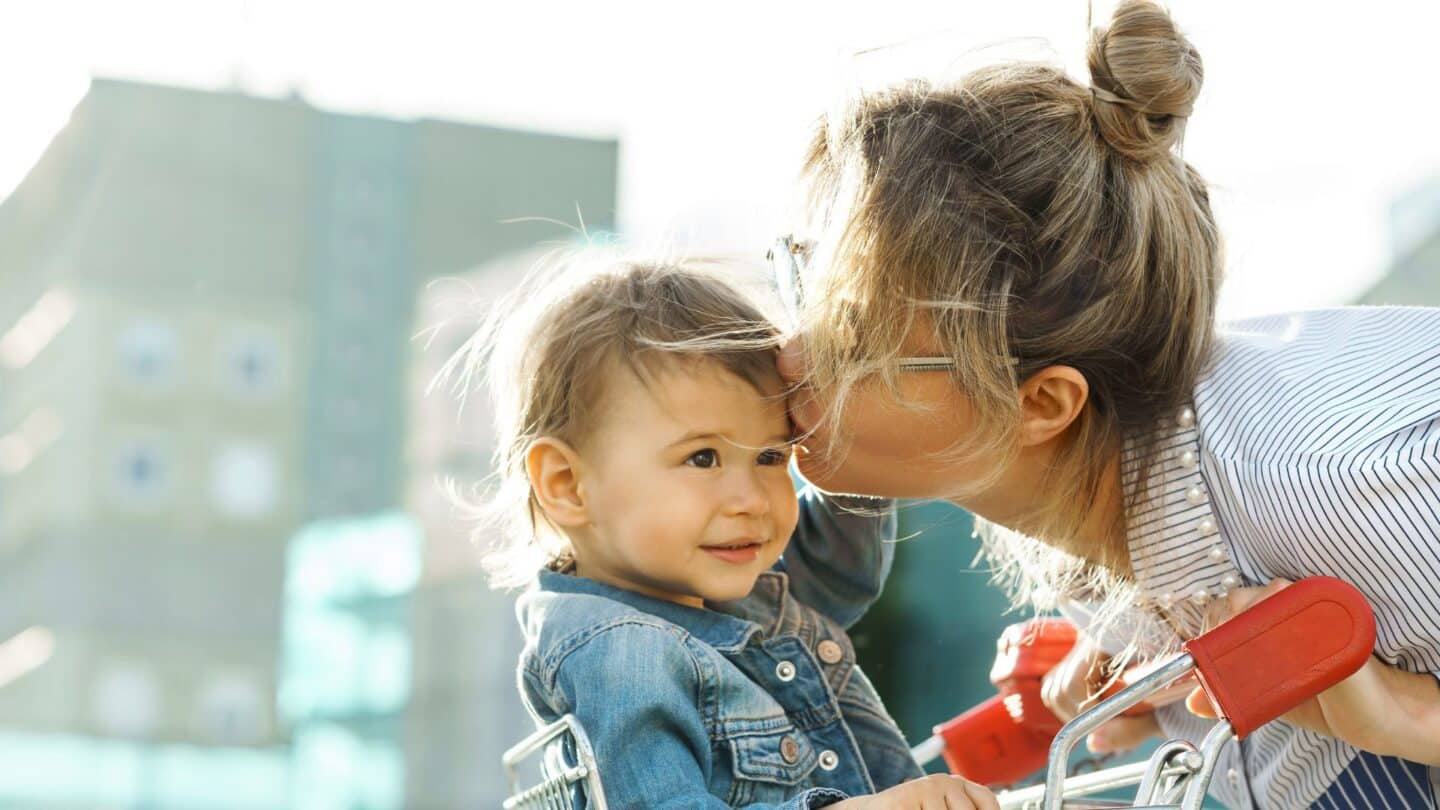 Target mom kissing baby in a store cart