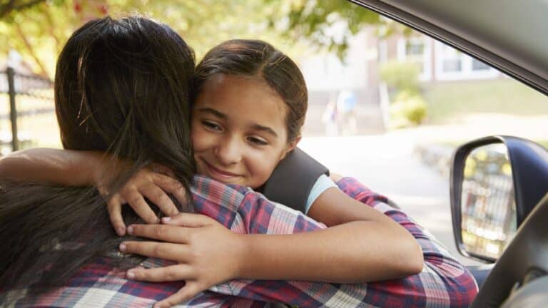 mom saying goodbye to her daughter at school drop off and pick up