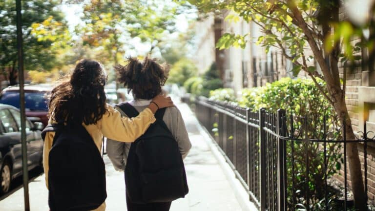 two kids walking to school wearing backpacks - do bulletproof backpacks work