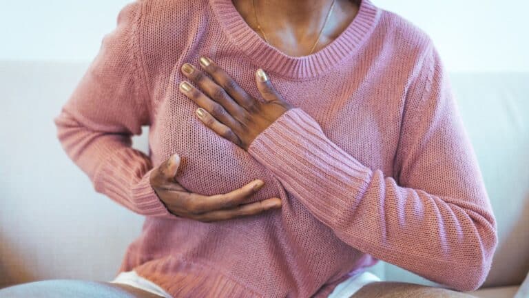 woman performing a self breast exam