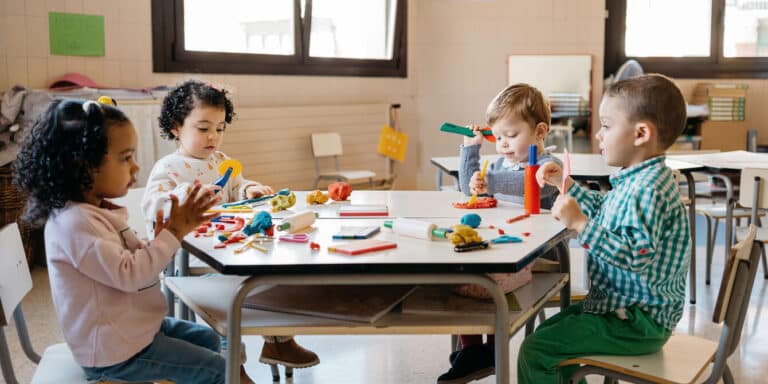 introverted child at school doing arts and crafts with other kids