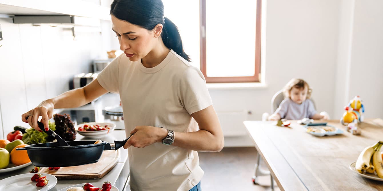 mom cooking in the kitchen for her child to help kids have a healthy relationship with food