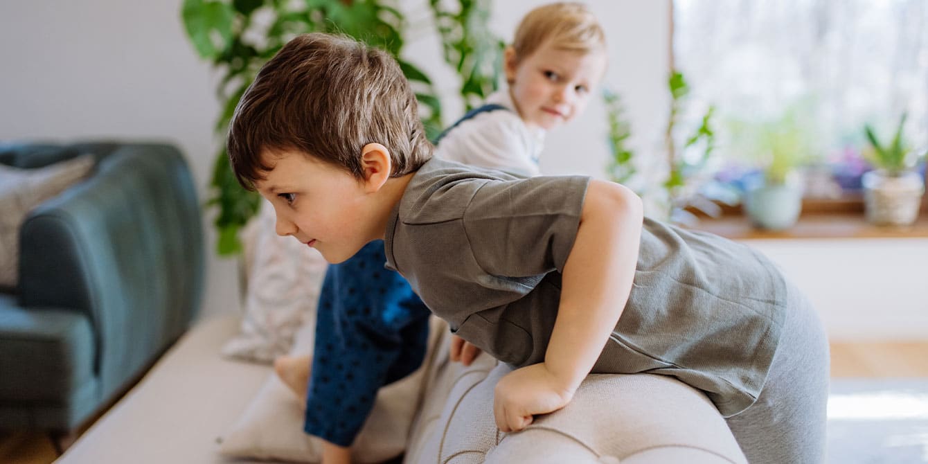 boys playing on couch - life of being a boy mom