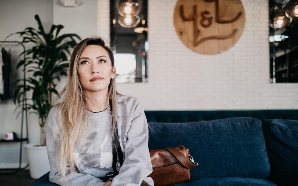 woman sitting on couch thinking Motherly