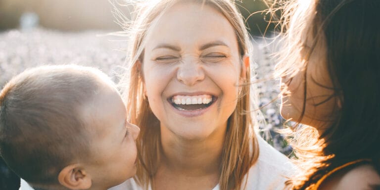 Mom laughing with kids thinking of her Capricorn mom traits