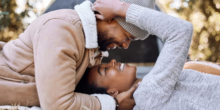 couple laying upside down embracing - myths about marriage