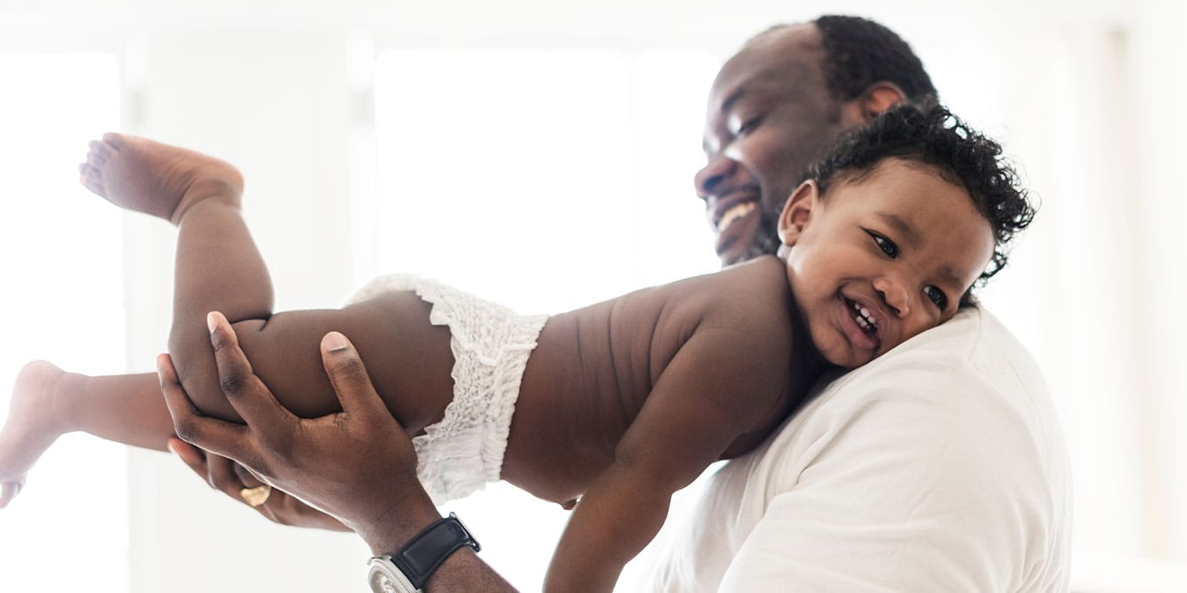 working dad playing with his baby