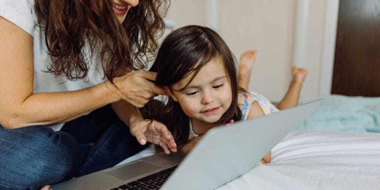 mother and daughter watching a show on the laptop- best educational shows for kids