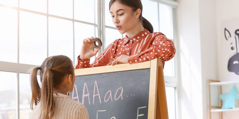 speech therapist working with young girl - dyslexia diagnosis