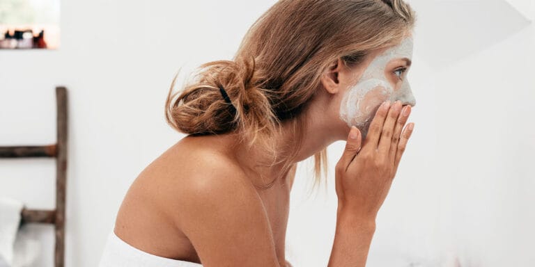 woman applying face mask - how to balance hormones