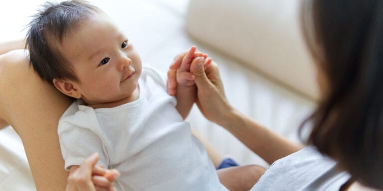 mom playing with 4-month-old baby -