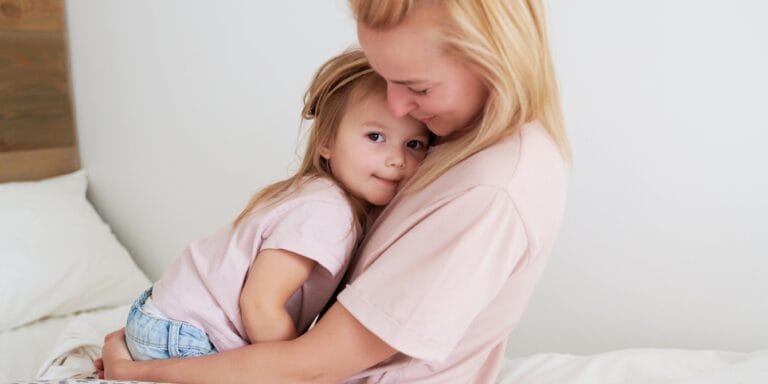 mom hugging daughter as she contemplates quitting a toxic job