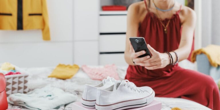 woman-photographing-to-sell-used-clothes