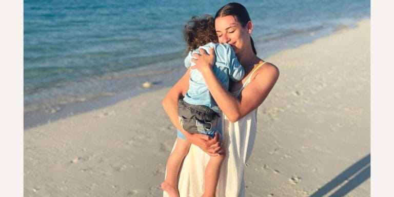 Lea Michele holding her son on the beach