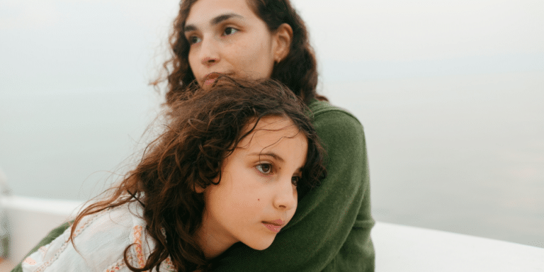 mother hugging daughter outside - talking to kids about fentanyl