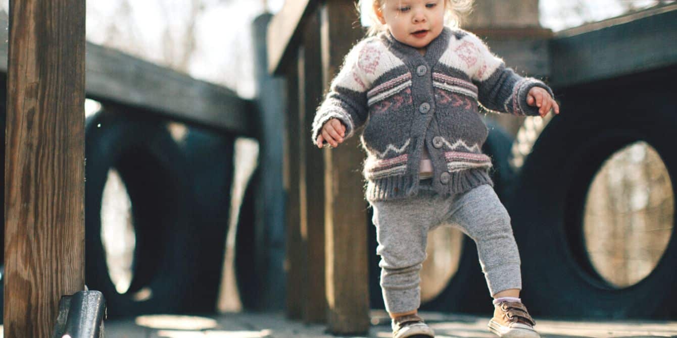 toddler girl playing at park - 15-month milestones