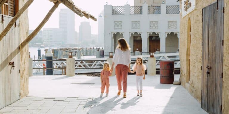 Mom walking with kids raising kids in Dubai