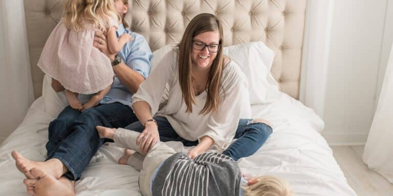 family playing on the bed- gender inclusive