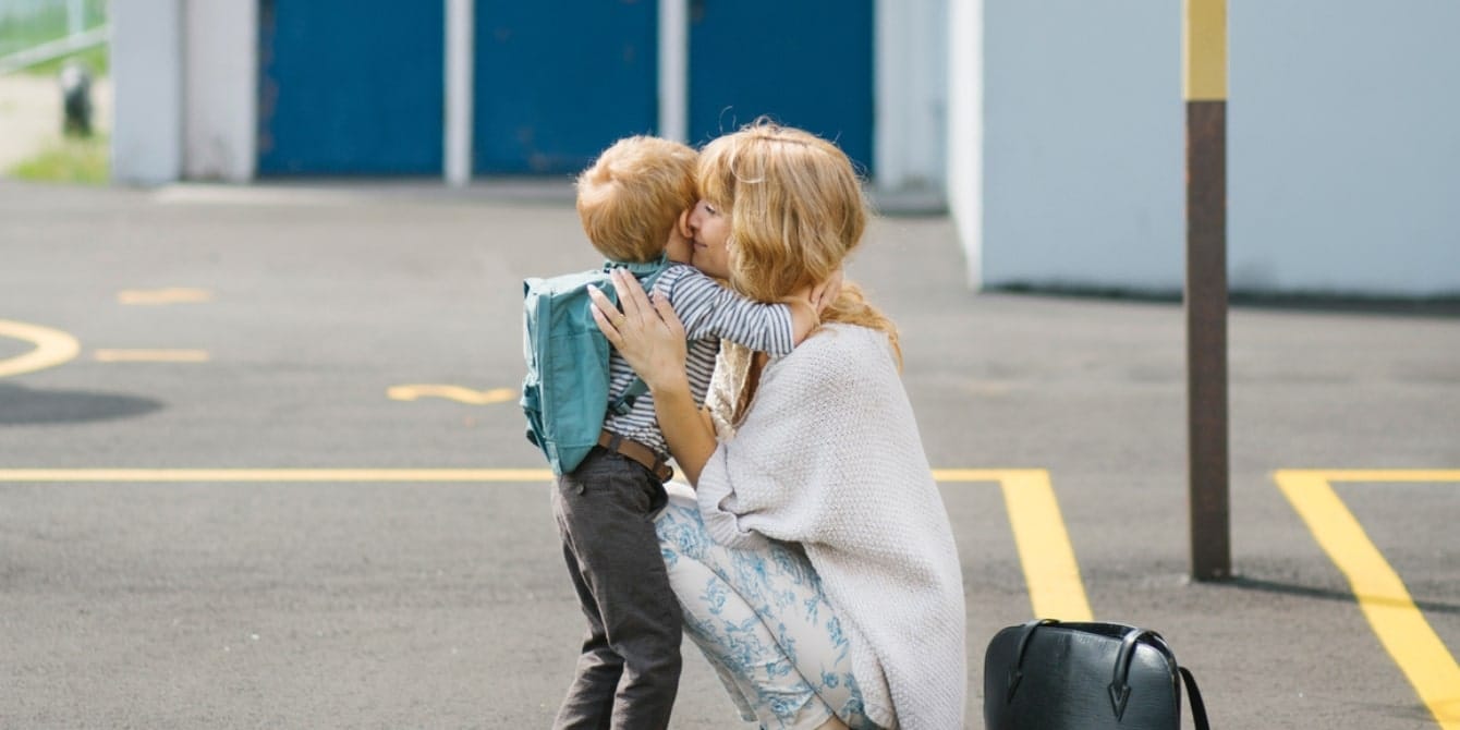 mother hugging preschool son at school dropoff - sending child to school