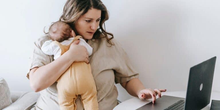 mom working from home with baby - childcare cliff will impact moms