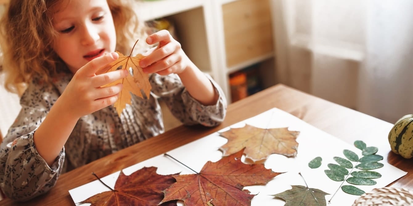 little girl doing fall crafts- autumn crafts for kids