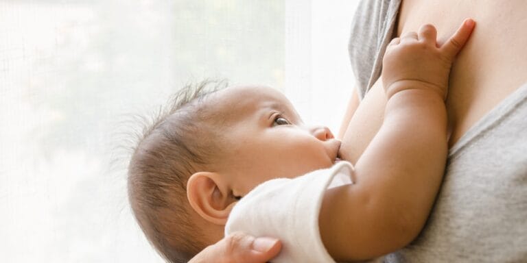 close up mother breastfeeding baby - cost of breastfeeding