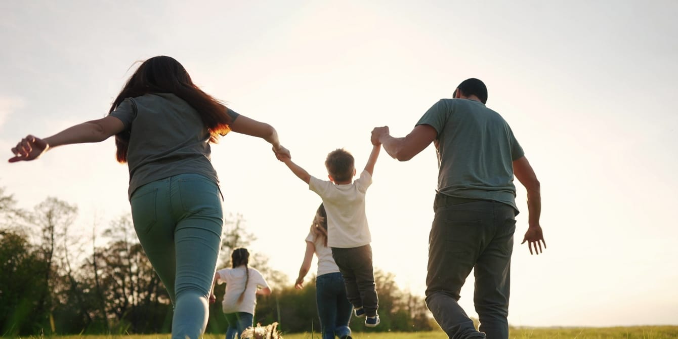 happy family running playing outside - should pediatricians prescribe play