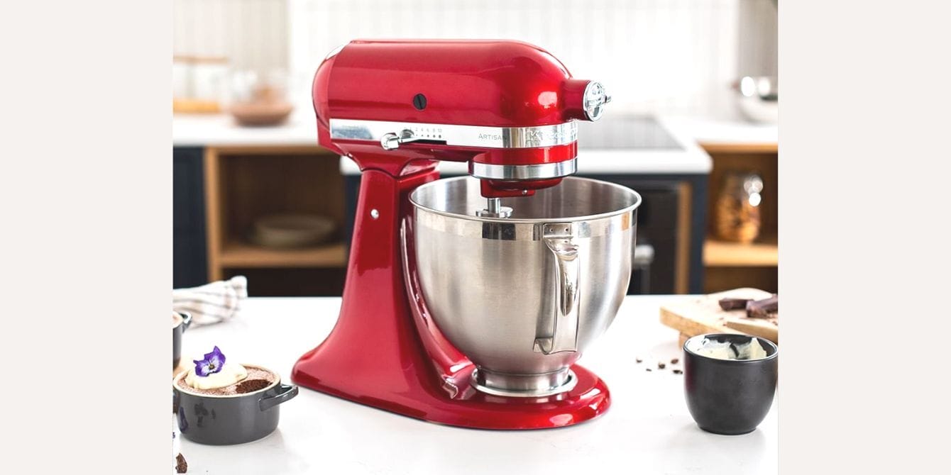 red kitchenaid mixer on top of a table