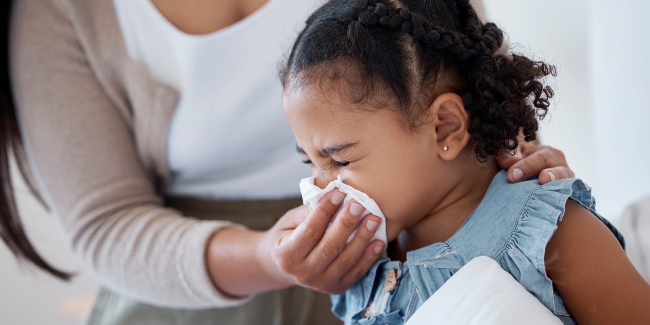 mom helping young daughter blow her nose - kids covid study